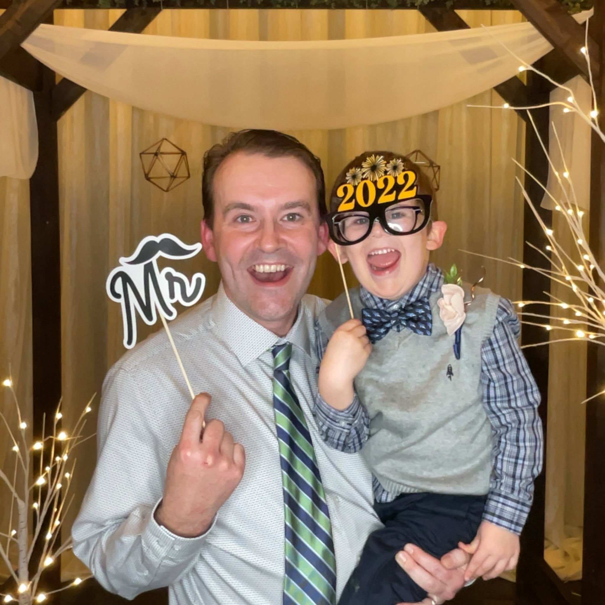 Father and son at a photo booth at Historic 1625 Tacoma Place