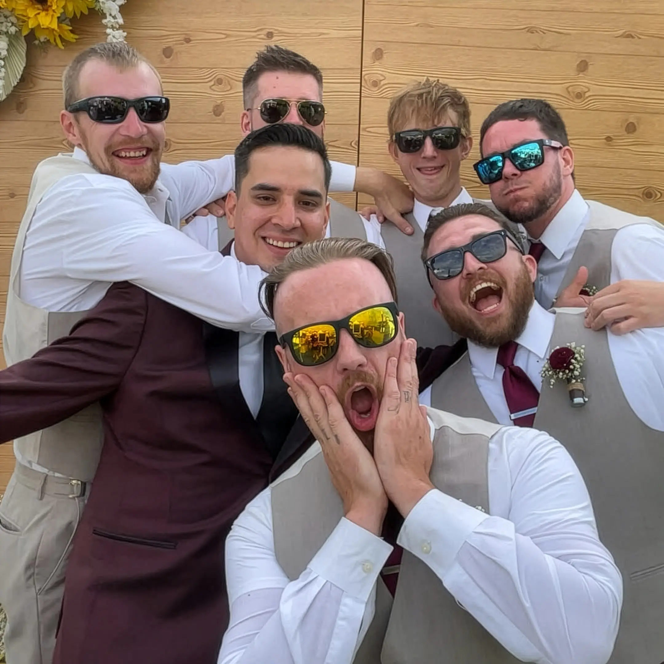 Groomsmen having fun with a wedding photo booth