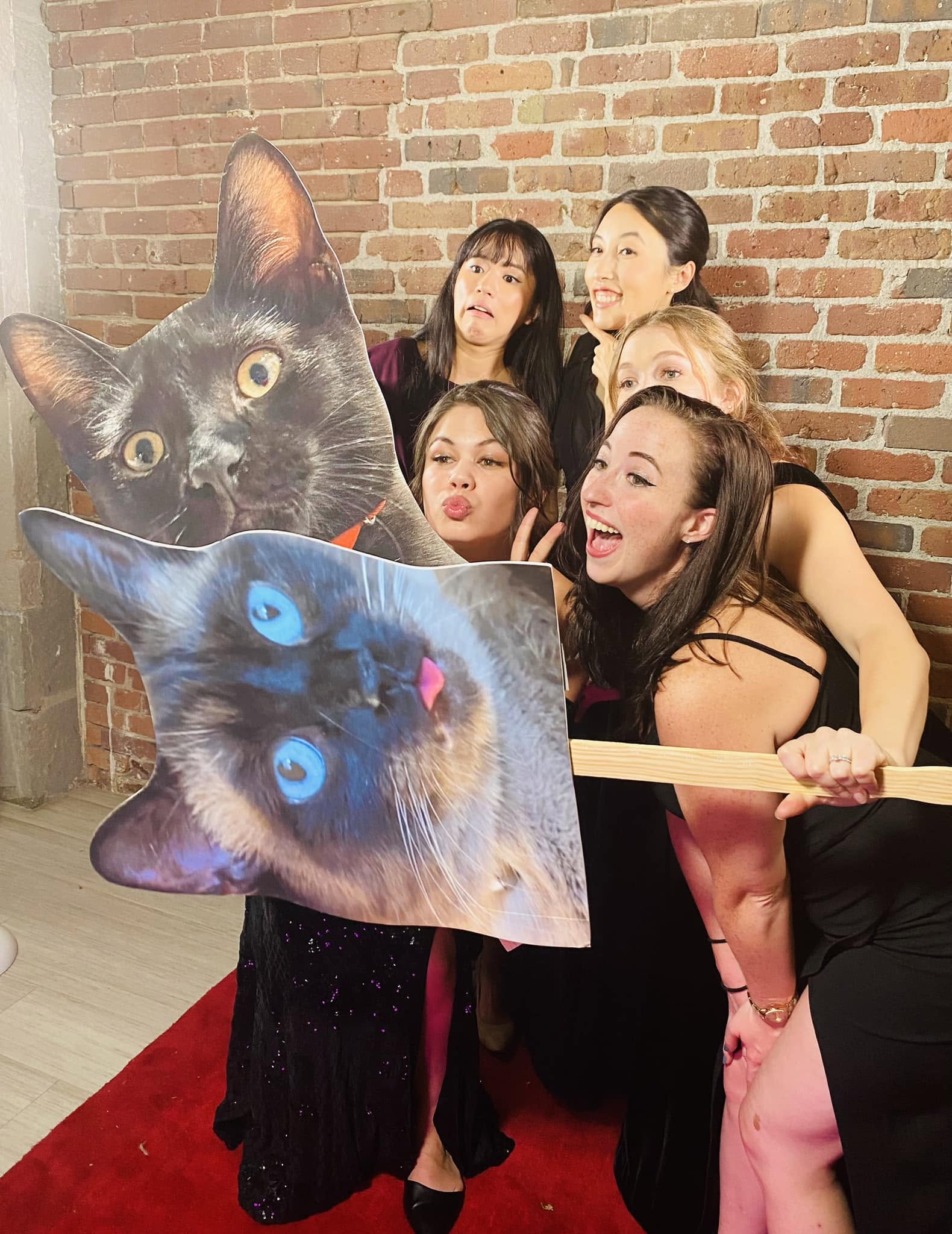 Wedding guests having fun posing together at a photo booth