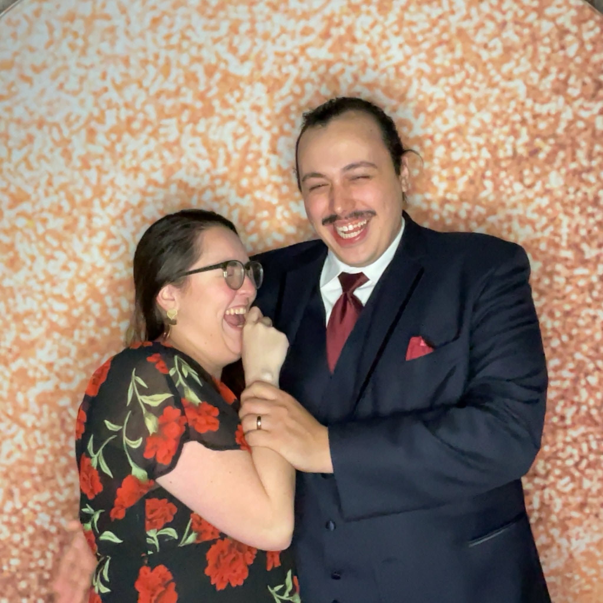 Wedding guests laughing together in a photo booth