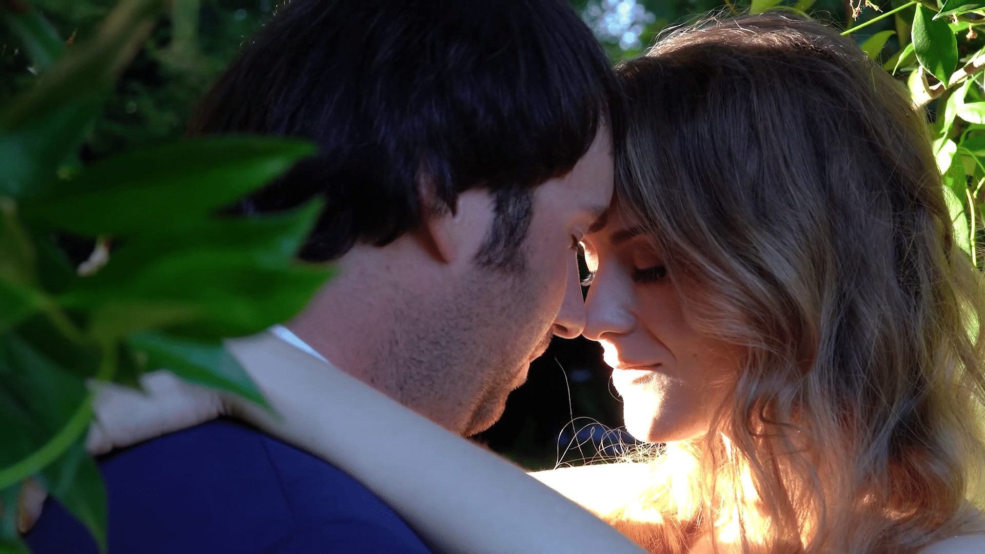 The couple sharing a close moment among the greenery at their McLean House wedding