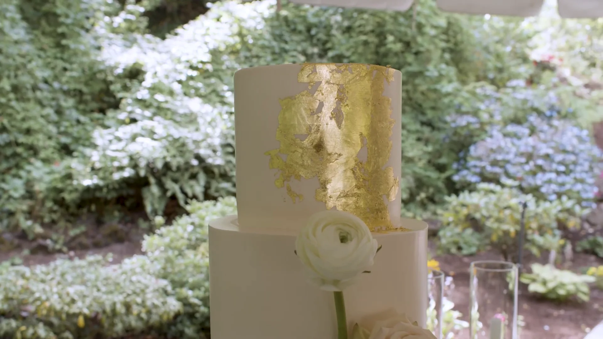 Video still of the wedding cake with floral decoration