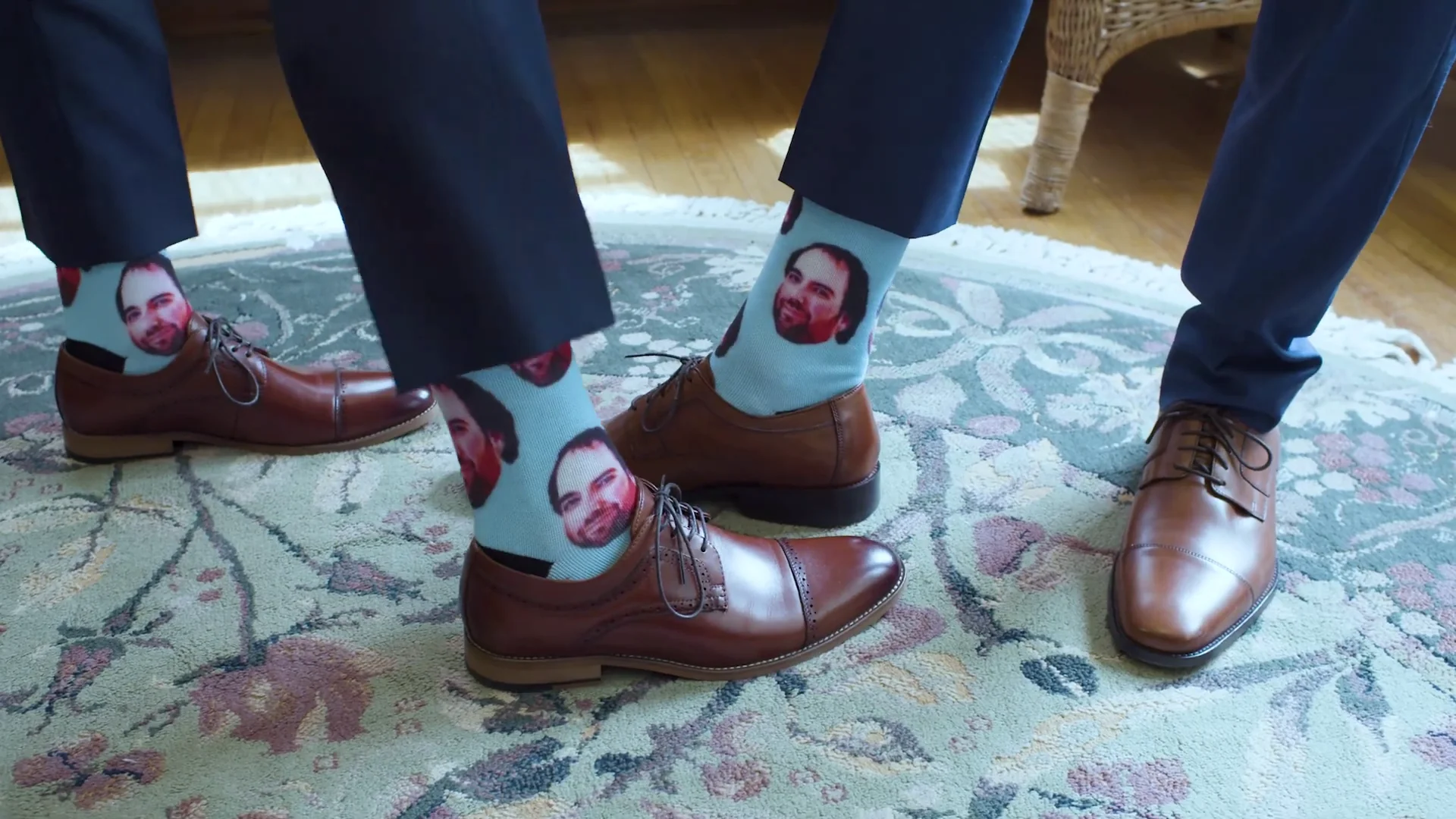 Video still showing playful patterned socks worn with wedding suits